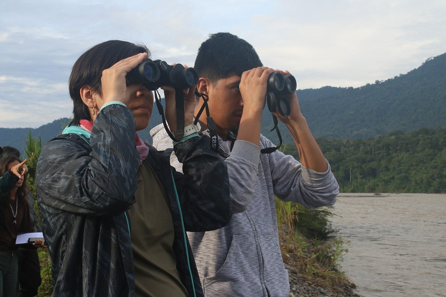 Two environmental interns gaining valuable experience while looking through binoculars.